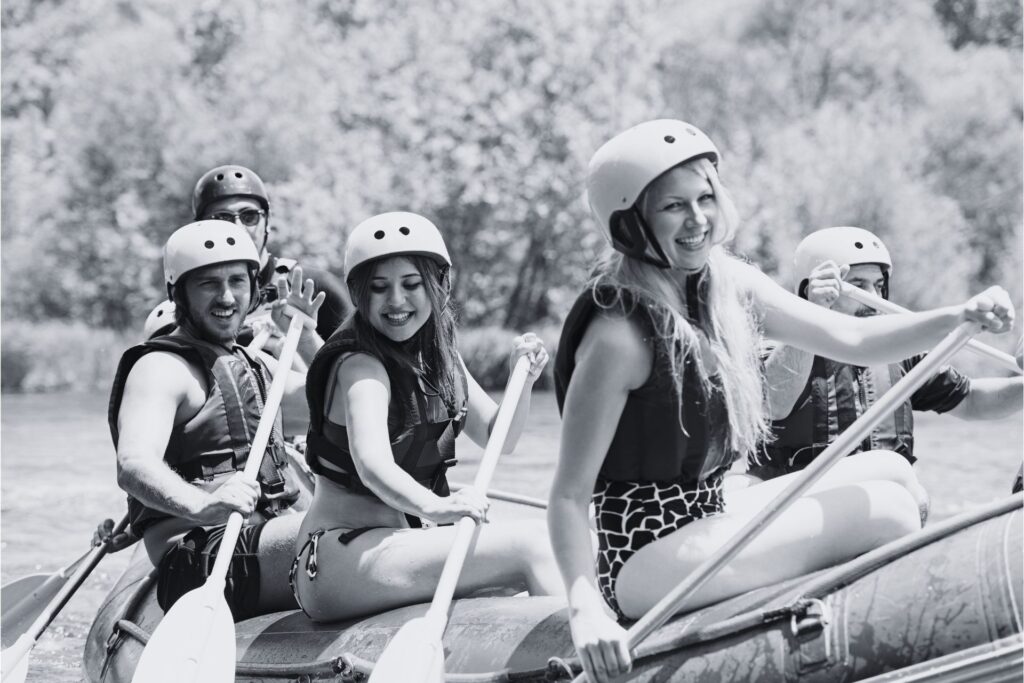 Mum smiles while white-water rafting with her family