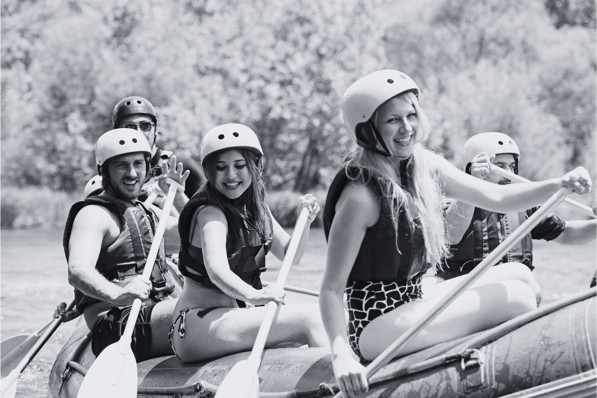 Mum smiles while white-water rafting with her family