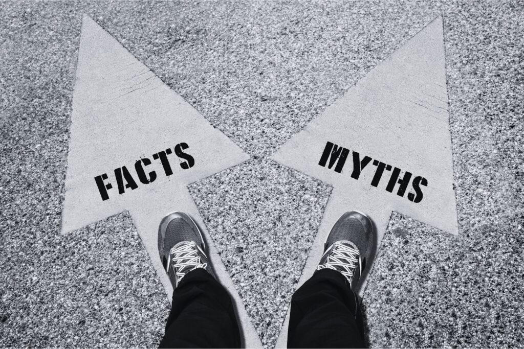 looking down at feet and two arrows, one saying 'myths' one saying 'facts'